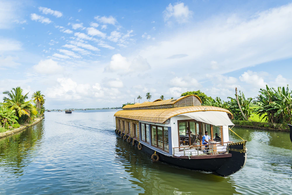 Traditional wooden houseboat floating on the serene backwaters of Alleppey